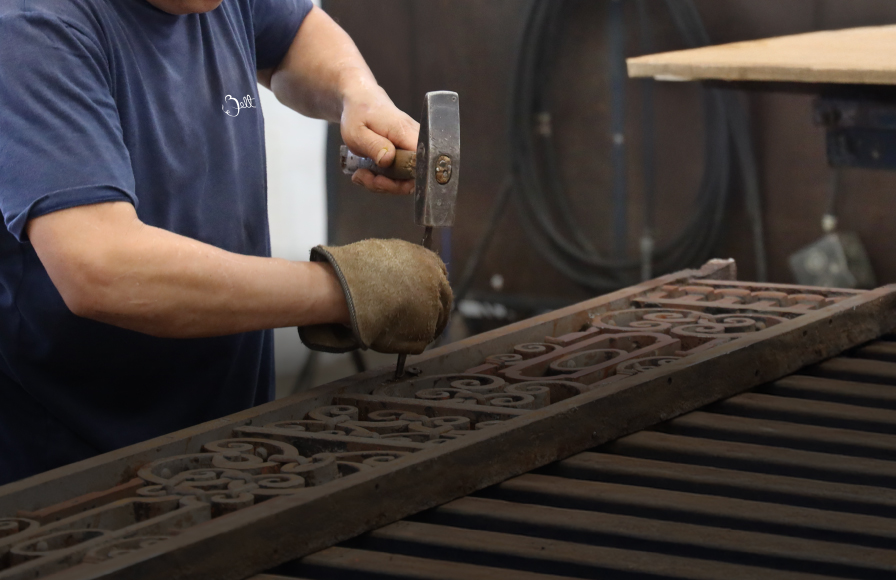 Artisan restoring metalwork